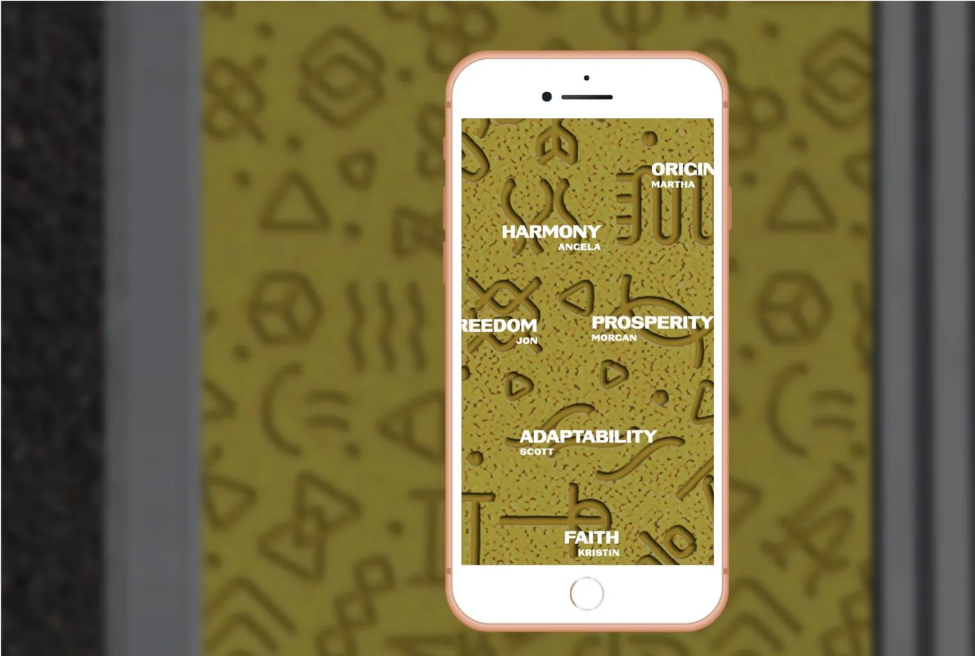 A phone over the pattern decoding glyphs into words like Harmony, Prosperity and Faith