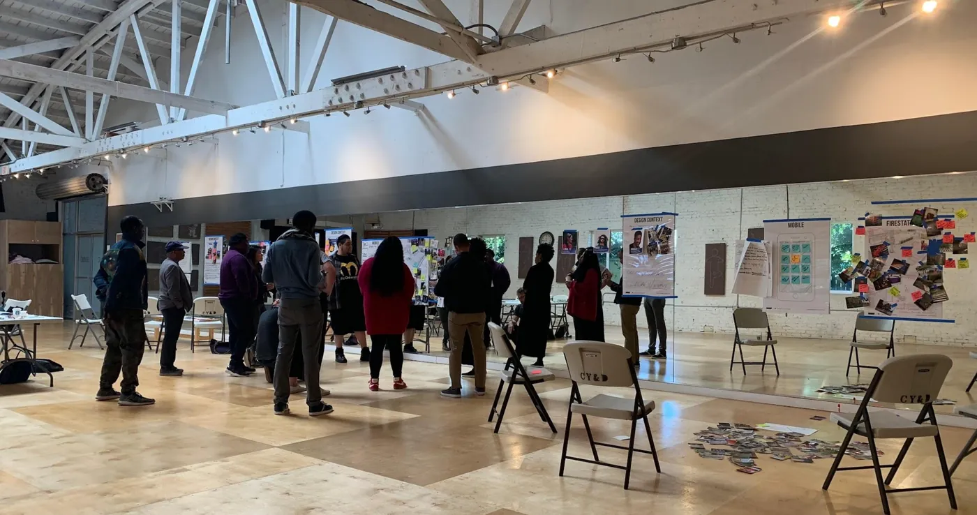 Participants moving between persona boards in a large studio space